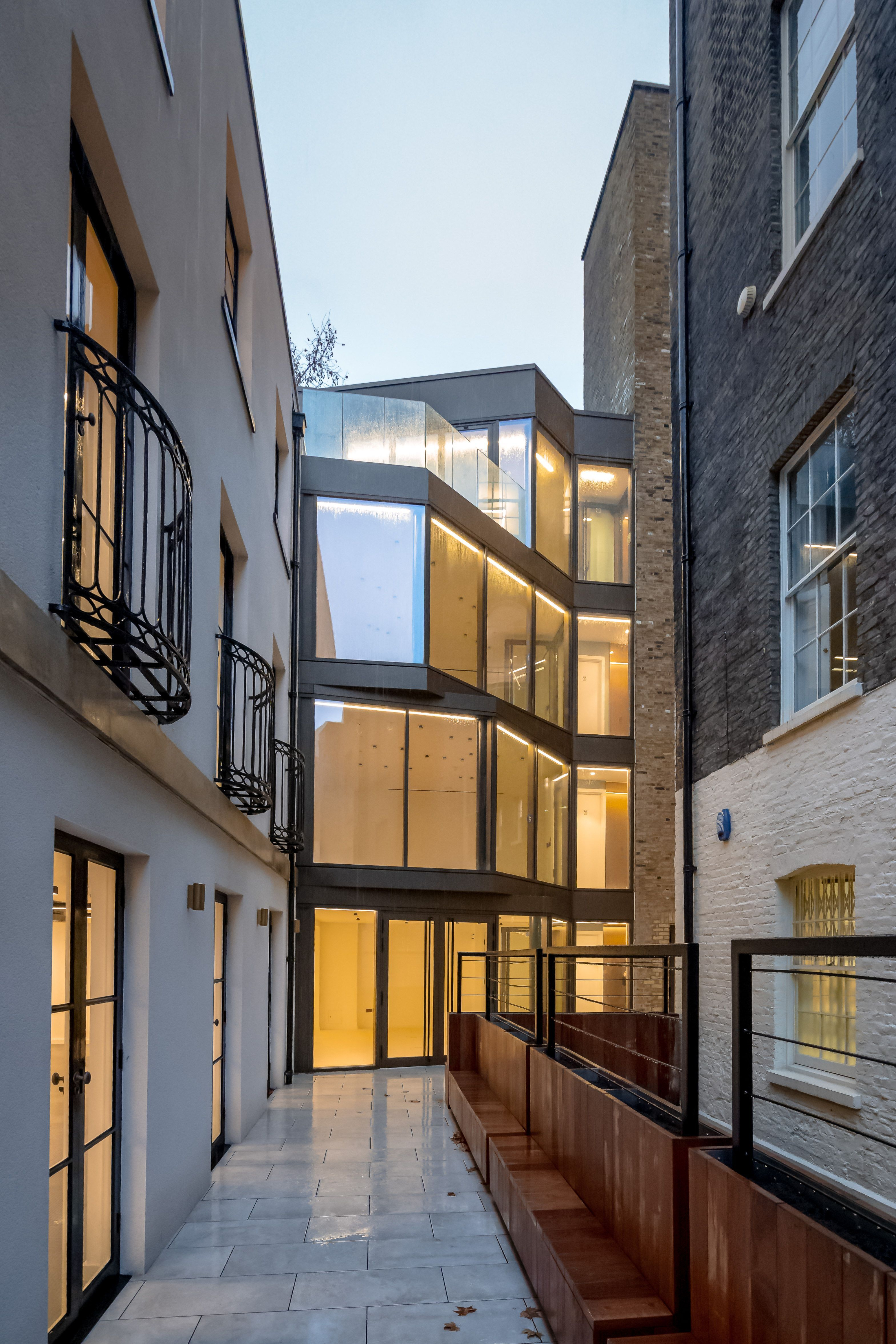 Illuminated contemporary glazing linking buildings around a London courtyard